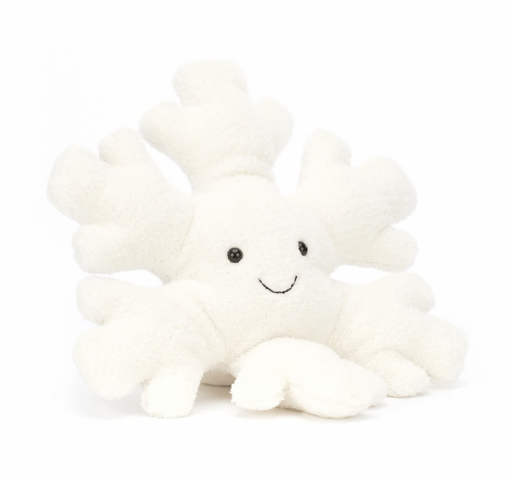 Une peluche en forme de flocon de neige blanche de la marque Jellycat. La peluche a un grand sourire.